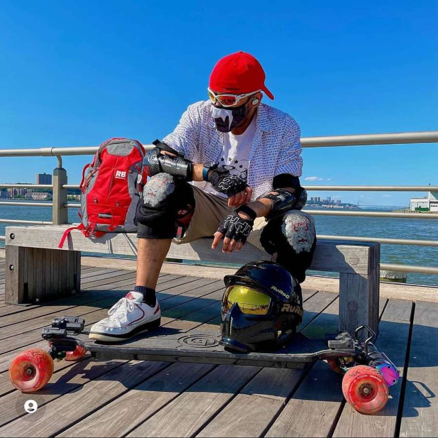 Man Posing With Red Reflective Backpack