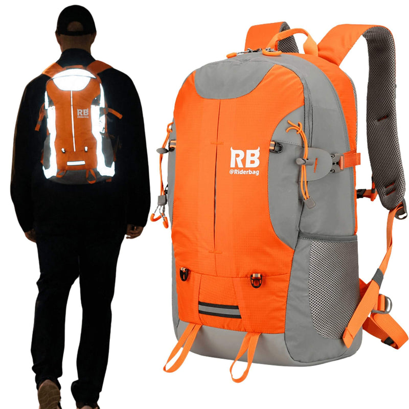 Laden Sie das Bild in Galerie -Viewer, An orange and gray backpack shown prominently in the foreground, with a person from the back wearing a reflective version of the same backpack on the left. The backpack features a white 'RB riderbug' logo on the front, mesh side pockets, compression straps, and a top carry handle, set against a plain white background.