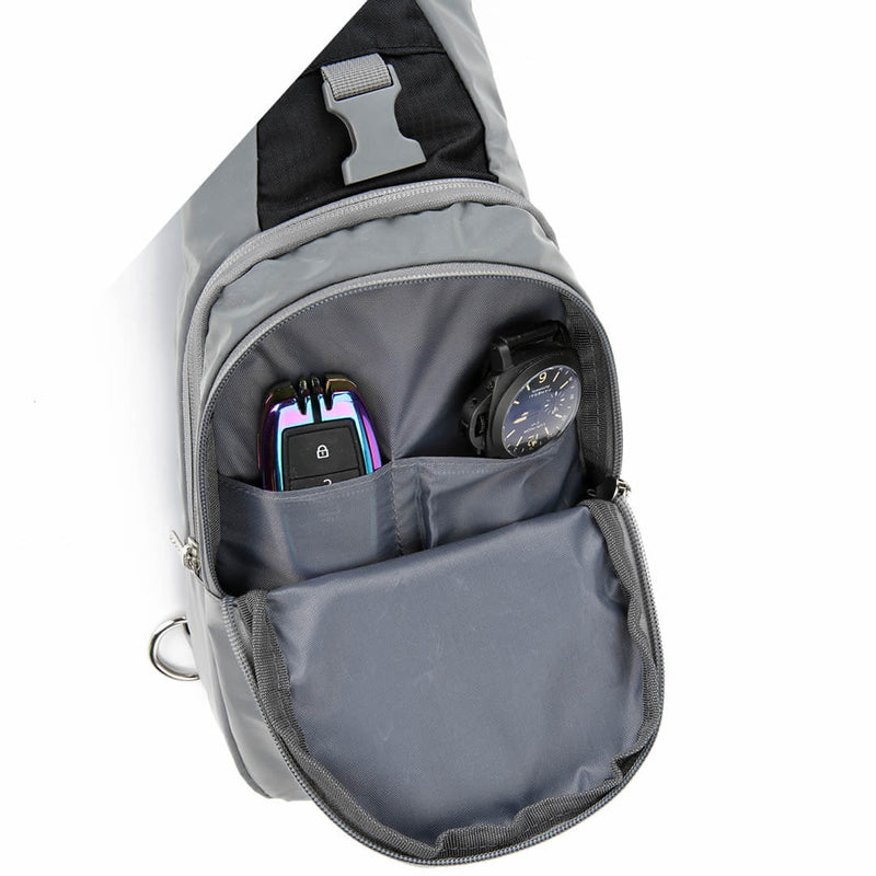 Load image into Gallery viewer, Main compartment of the Riderbag sling bag open, holding a phone, a watch and a card in the internal organiser pockets