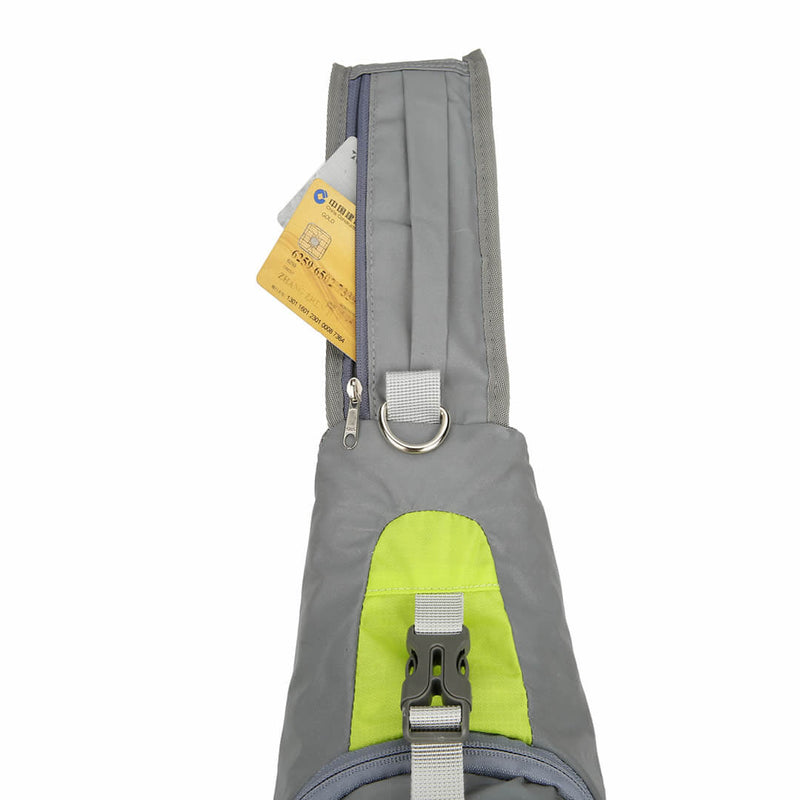 Laden Sie das Bild in Galerie -Viewer, Close-up of the green sling bag's internal zippered security pocket holding travel documents and cards
