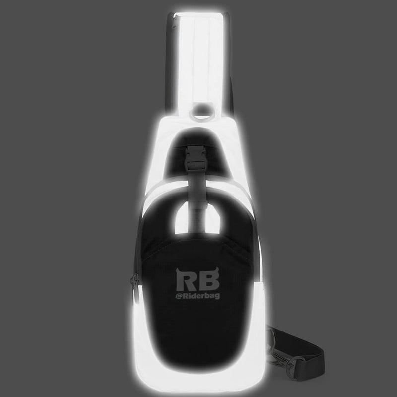Load image into Gallery viewer, Riderbag black sling bag photographed with flash in the dark, reflective panels lighting up bright white