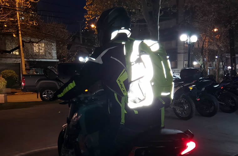 motorcycle rider wearing a high visibility backpack and reflective backpack, rider bag, reflective bakpack, hi viz, hi vis