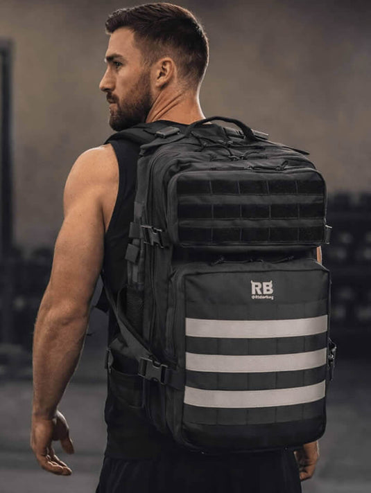 Man wearing a black tactical gym backpack with Riderbag logo in the gym