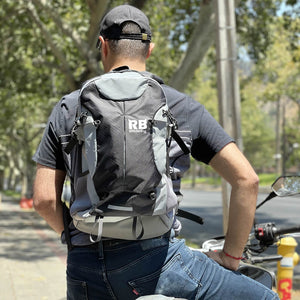 man hiking with black reflective backpack